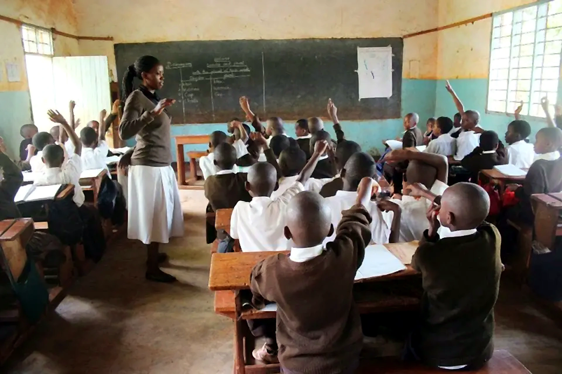 Teacher and pupils in a classroom connected to OEF education work